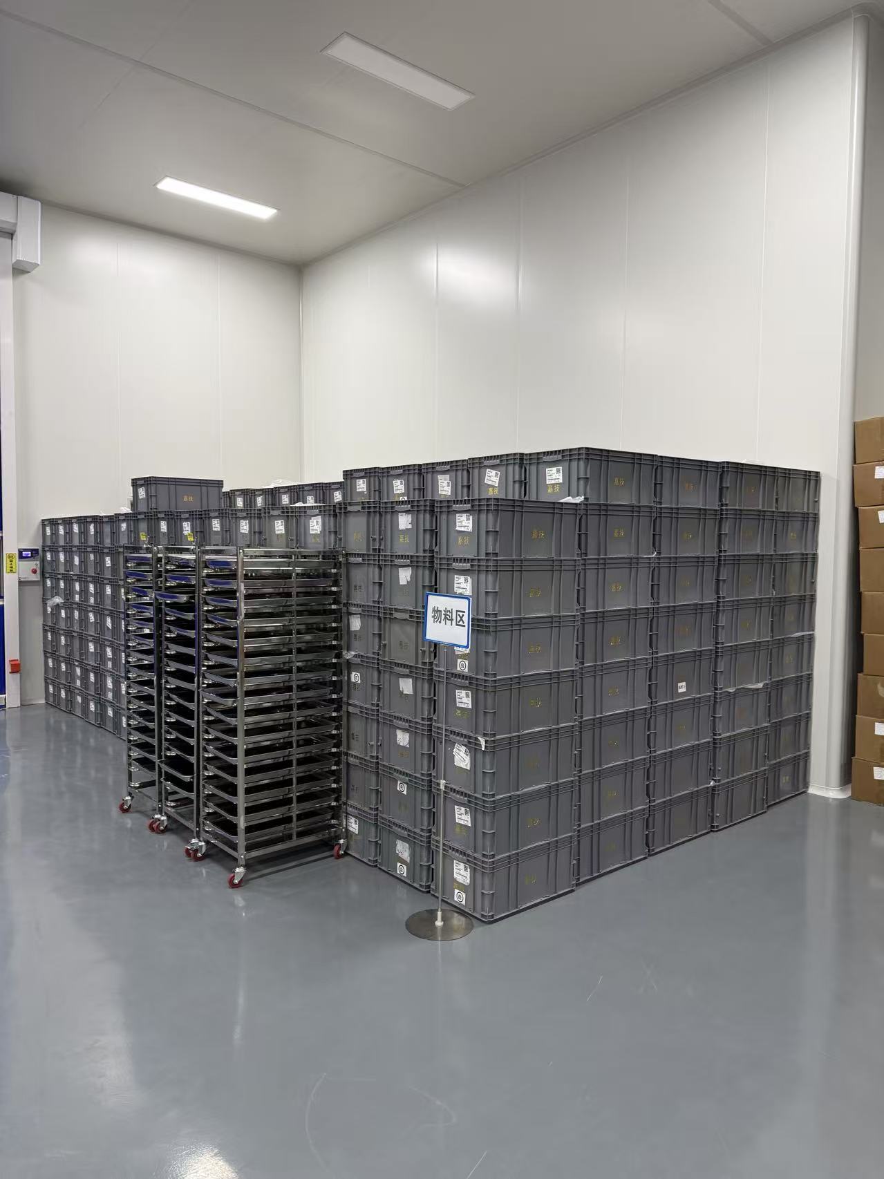 Raw material storage — lot-traced material bins in a temperature-controlled storage room